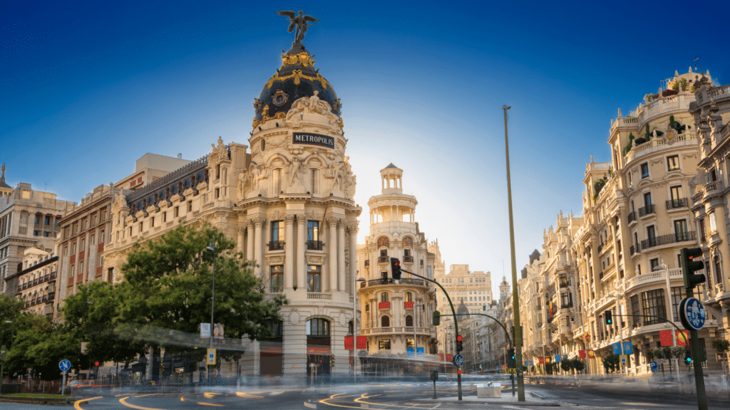 Madrid’s ornate Metrópolis Building with its dark dome and winged rooftop statue.
