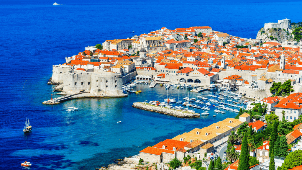 Panoramic view of Dubrovnik Old Town, red-tiled rooftops and the blue Adriatic Sea along Croatia’s Dalmatian coast